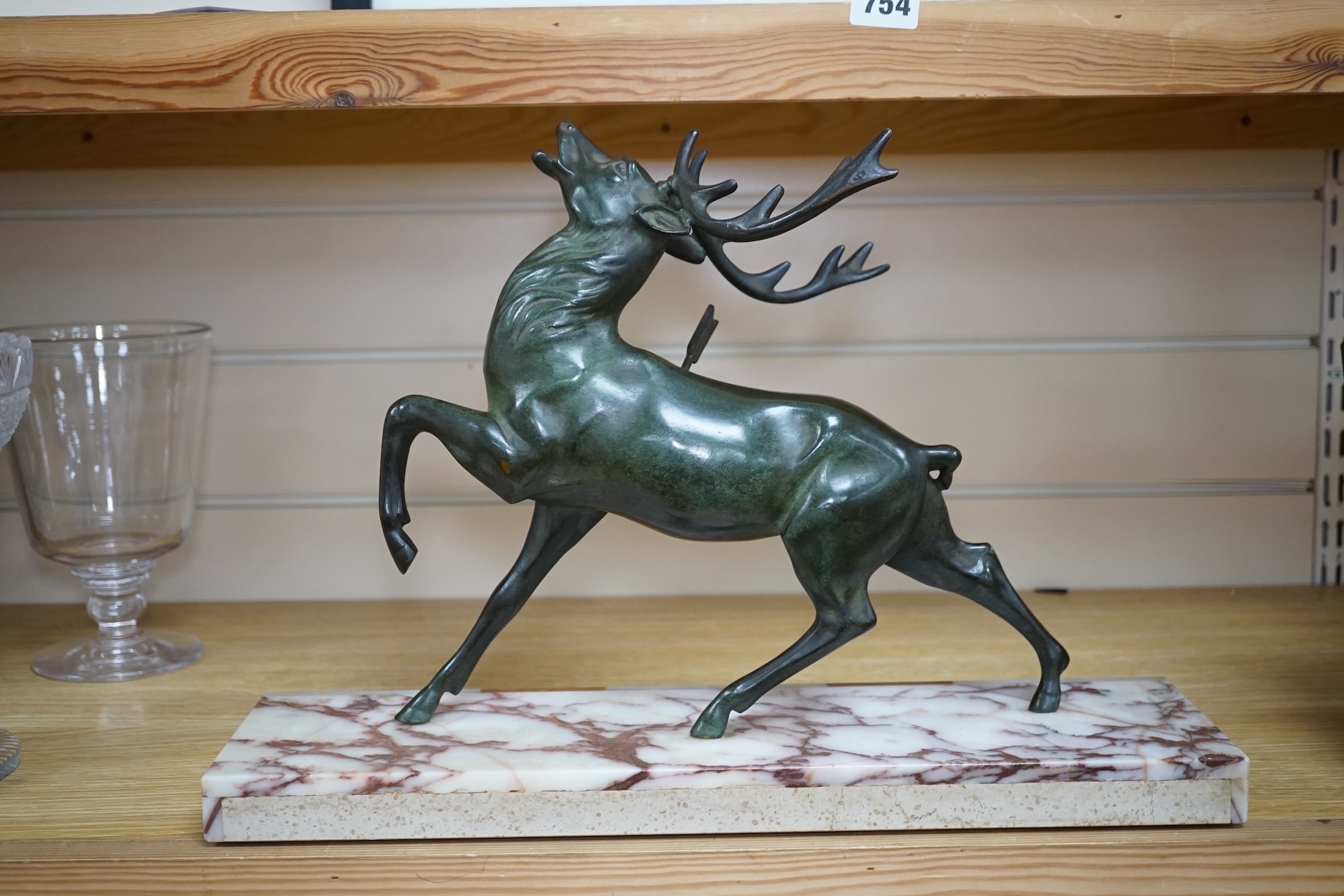 A bronze model of a stag raised on rectangular marble base, 45cm wide. Condition - good